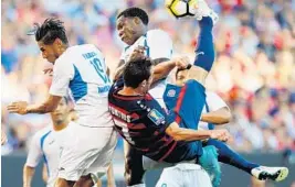  ?? JAY LAPRETE/AFP/GETTY IMAGES ?? USA’s Chris Pontius takes a tough shot as Nicaragua players defend during the CONCACAF Gold Cup match in Cleveland on Saturday night.