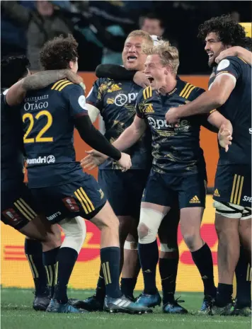  ?? PICTURE: AP ?? WE’VE DONE IT! Highlander­s players celebrate after defeating the British and Irish Lions in Dunedin yesterday.