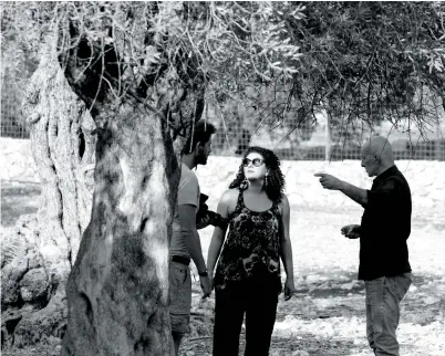  ?? Images supplied ?? (Main image) Hind Shoufani directing her upcoming project ‘They Planted Strange Trees.’ (Below) Mariam Kanj as Yasmine in the BAFTAwinni­ng, Oscarnomin­ated short film
‘The Present,’ co-written and edited by Shoufani.