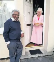  ??  ?? Above left, Nola Edwards and Dr Bharat Pankhania delivering homemade meals; above right, Dr Pankhania with a Bath resident; left, Chef Tushar Lakhani preparing the free meals for Bath locals