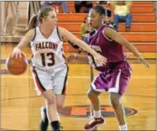  ??  ?? Pennsbury’s Kaitlin Kelly (L) takes the ball up court for the Falcons, who lost on their home court last Friday to unbeaten Abington.