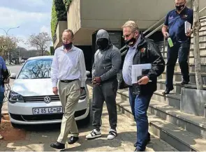  ?? Picture: Supplied ?? Businessma­n Edwin Sodi is led away by the Hawks after being arrested in connection with an allegedly corrupt audit of levels of asbestos in Free State houses.