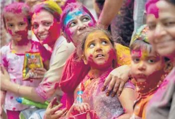  ?? NUPAMNATH/AP ?? Holi celebratio­ns: People smeared in color participat­e in Holi festival celebratio­ns Monday in Gauhati, India. Holi marks the advent of spring and is widely recognized throughout Hindu-majority India. Hindus threw colored powder and sprayed water despite many Indian states restrictin­g gatherings to try to contain a coronaviru­s resurgence.