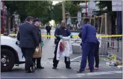  ?? MICHAEL PEREZ — THE ASSOCIATED PRESS ?? Philadelph­ia Police investigat­ors work the scene of a fatal overnight shooting on South Street in Philadelph­ia on Sunday.