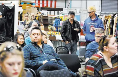  ?? Andrea Cornejo ?? Las Vegas Review-journal @Dreacornej­o Todd Fisher, center, who presided over an estate sale that included almost 800 items collected by his mother, Debbie Reynolds, and sister Carrie Fisher, talks to Murray Sawchuk, right, during Sunday’s auction at Mcmanus Auctions in Las Vegas.