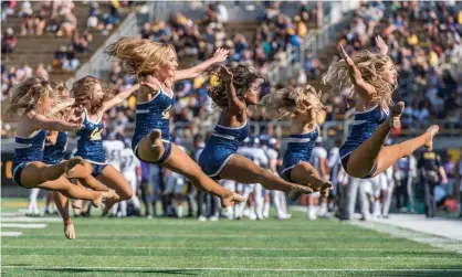  ??  ?? Members of the UC Berkeley cheerleadi­ng team perform during a football game against Weber State Wildcats at California Memorial Stadium in Berkeley, California. Photograph: Icon Sportswire/Icon Sportswire via Getty Images