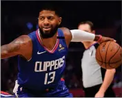  ?? AP PHOTO BY MARK J. TERRILL ?? Los Angeles Clippers guard Paul George drives against the Philadelph­ia 76ers during the first half of an NBA basketball game in Los Angeles, in this March 1, 2020, file photo. Paul George wants to retire with the Los Angeles Clippers, and he took a step in that direction by signing a multiyear contract extension on Thursday, Dec. 10.