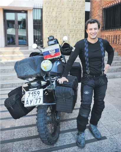  ?? Picture: Jacques Nelles ?? WELL-TRAVELLED. Adventurer Oleg Kharitonov poses for a picture next to his custom Russian-built motorcycle outside the Russian Embassy in Pretoria.