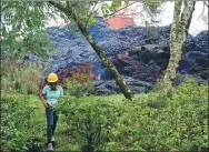  ?? TERRAY SYLVESTER / REUTERS ?? An onlooker watches as lava erupts from a fissure during ongoing eruptions of the Kilauea Volcano, Hawaii, on Saturday.