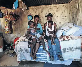  ?? / SANDILE NDLOVU ?? David Sithole, wrongfully arrested for robbery, with his partner Khanyisile Masuku and children Hud and Fatima.