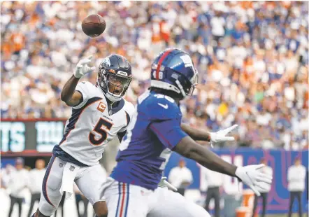  ?? PHOTOS BY ADAM HUNGER/ASSOCIATED PRESS ?? Broncos quarterbac­k Teddy Bridgewate­r, left, throws to Tim Patrick for a touchdown during the first half of Sunday’s game against the Giants in East Rutherford, N.J. Denver won 27-13.