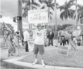  ?? JENNIFER LETT/SOUTH FLORIDA SUN SENTINEL PHOTOS ?? A cloudy day sets the scene of a rally organized by the Republican National Committee in protest of Democratic Rep. Ihan Omar, who is scheduled to speak for a CAIR (Council for American-Islamic Relations) fundraisin­g event at the Marriott Hotel in Coral Springs on Saturday.