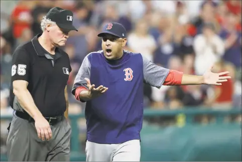  ?? Tony Dejak / Associated Press ?? Boston Red Sox manager Alex Cora, right, argues a call with firstbase umpire Ted Barrett in the eighth inning on Tuesday in Cleveland.