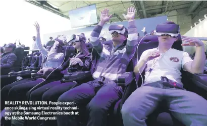  ??  ?? REALITY REVOLUTION. People experience skiing using virtual reality technology at the Samsung Electronic­s booth at the Mobile World Congress.