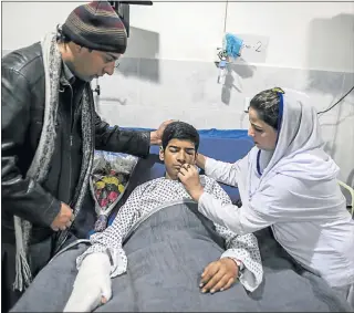  ?? Picture: REUTERS ?? TENDER CARE: Teenager Mehran Khan, 14, who was wounded in the attack by Taliban gunmen on the Army Public School, is treated in hospital in Peshawar, Pakistan. Pressure is being increased on the Pakistani government to do more to tackle the insurgency