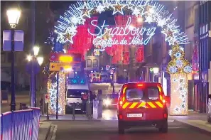  ?? Associated Press ?? ■ In this image made from video, emergency services arrive Tuesday on the scene of a Christmas market in Strasbourg, France. A French regional official says that a shooting in Strasbourg has left at least four dead and several wounded in the city center near a world-famous Christmas market. The prefect of France's Bas-Rhin region says the gunman, who is still at large, has been identified. Authoritie­s haven't given a motive for the shooting.