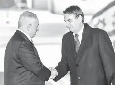  ??  ?? Netanyahu (left) shakes hands with Bolsonaro upon the latter’s arrival atTel Aviv Ben Gurion Internatio­nal Airport in his first state visit to Israel. — AFP photo