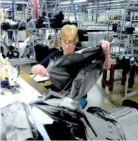  ?? STAFF FILE PHOTO ?? Sandra Woolsey sews at Hardwick Clothes in Cleveland in 2014.