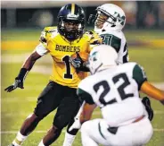  ?? [PHOTO BY STEVE SISNEY, THE OKLAHOMAN] ?? Juwan Walker runs as the Midwest City Bombers play the Muskogee Roughers in high school football on Friday in Midwest City.