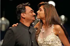  ?? File/agence France-presse ?? Deepika Padukone (right) kisses Wendell Rodricks at the end of the presentati­on of his collection at the Wills Lifestyle India Fashion Week Spring Summer 2012 in New Delhi.