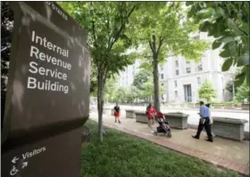  ?? ANDREW HARNIK — THE ASSOCIATED PRESS FILE ?? The Internal Revenue Service Building is seen in Washington. The tax overhaul bill has yet to be passed at this point. But if it does, those changes will take effect in 2018. The IRS said that it is closely monitoring the bill and expects to issue...