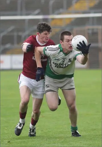  ??  ?? St James’ Paul Barron battles with Ciaran Redmond of St Martin’s.