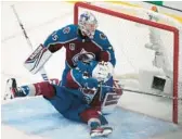  ?? DAVID ZALUBOWSKI/AP ?? Avalanche center Nazem Kadri, front, slides into goalie Darcy Kuemper after he deflected a shot by the Lightning during Game 5 on Friday in Denver.