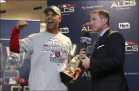  ?? ELSA GARRISON/GETTY VIA AP, POOL ?? Boston Red Sox manager Alex Cora celebrate with the William Harridge Trophy in the clubhouse after defeating the Houston Astros 4-1in the baseball American League Championsh­ip Series on Thursday, Oct. 18, 2018, in Houston.