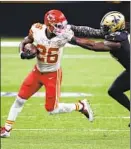  ?? Tyler Kaufman Associated Press ?? CHIEFS running back Le’Veon Bell ( 26) is tackled by Demario Davis during Kansas City’s ninth straight win.