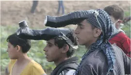  ??  ?? Palestinia­n demonstrat­ors use taped plastic bottles as makeshift teargas masks.