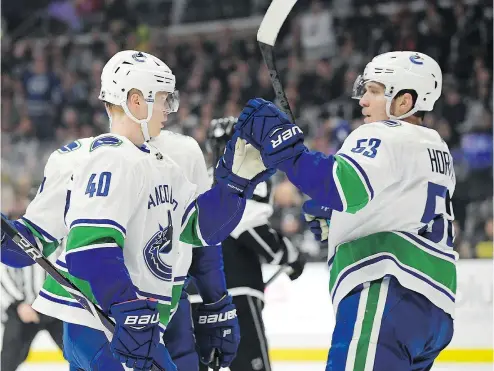  ??  ?? Canucks forward Elias Pettersson, left, celebrates his goal with forward Bo Horvat during the first period against the Kings at the Staples Centre in Los Angeles on Thursday.