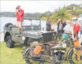  ??  ?? Mike Pooley took advantage of the 1942 Jeep on display at Mangonui’s service to gain a little elevation for his camera.