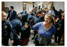  ?? TASOS KATOPODIS / GETTY IMAGES ?? Protesters are detained near the Senate budget committee markup of tax reform legislatio­n on Capital Hill on Tuesday. Senate Republican­s hope to pass legislatio­n this week and get a bill to the president before Christmas.