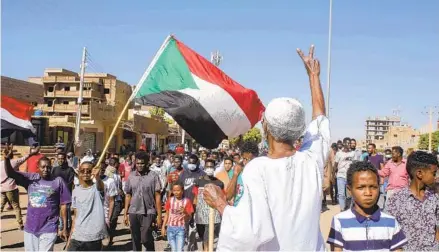  ?? AFP VIA GETTY IMAGES ?? A Sudanese man flashes the victory sign as protesters rally to call for a return to civilian rule in the Sudanese capital of Khartoum on Sunday. The deposed prime minister signed a deal with military leaders after a coup put him under house arrest for nearly a month.