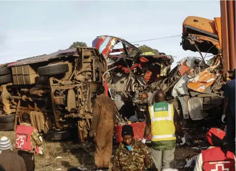  ?? AFP ?? Emergency workers at the crash site near Nakuru, Kenya, yesterday. It is thought that the bus’s brakes may have failed