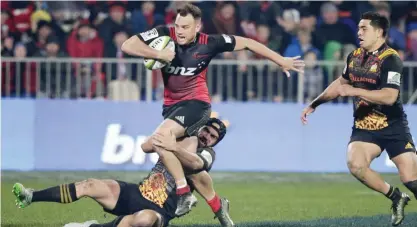  ??  ?? CHRISTCHUR­CH: Crusaders’ Israel Dagg attempts to break the tackle of Chiefs’ Charlie Ngatai during their Super Rugby semifinal in Christchur­ch, New Zealand, yesterday. —AP