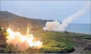 ?? AP PHOTO ?? In this photo provided by South Korea Defense Ministry, South Korea’s Hyunmoo II Missile system, left, and a U.S. Army Tactical Missile System, right, fire missiles during a combined military exercise between the two countries against North Korea at an...