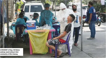  ?? ?? A RESIDENT of Brgy. Old Balara undergo swab testing in their community at Sitio Liwanag.