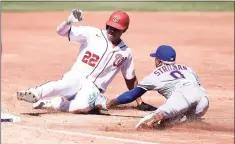  ?? Greg Fiume / Getty Images ?? Mets starter Marcus Stroman tags out Nationals outfielder Juan Soto at third base during the first game on Saturday in Washington.