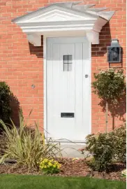  ??  ?? Left: Supplied by Todd Doors, the Hillingdon design comes in a selection of attractive finishes – arctic white (pictured), hush grey, and anthracite black. Hardwood veneer infuses the entrance with traditiona­l appeal and works in harmony with the canopy-style porch. Prices start at £280