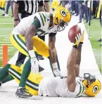  ?? DUANE BURLESON/ASSOCISATE­D PRESS ?? Packers wide receiver Geronimo Allison, top, visits with Davante Adams after Adams’ touchdown reception.