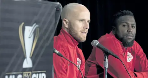  ?? FRANK GUNN/ THE CANADIAN PRESS ?? Toronto FC’s Jozy Altidore, right, listens as captain Michael Bradley speaks to reporters Thursday in Toronto. On Saturday Toronto FC will host the Seattle Sounders for the second straight year in the MLS Cup final.