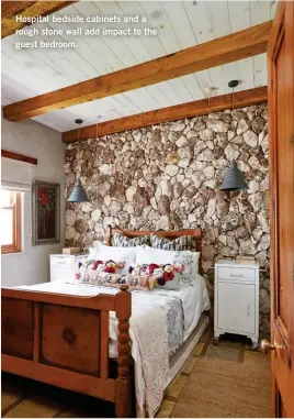  ??  ?? Hospital bedside cabinets and a rough stone wall add impact to the guest bedroom.