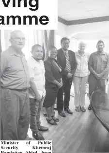  ??  ?? Minister of Public Security Khemraj Ramjattan (third, from right) with Sabine McIntosh, Director of the Deaf Associatio­n of Guyana (second, from right), Beverly Pile (at centre) of the National Commission on Disability and others last Thursday. (Ministry of Public Security photo)