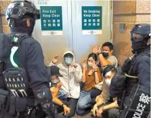  ?? Reuters-Yonhap ?? Riot police detain protesters during a march against national security law at the anniversar­y of Hong Kong’s handover to China from Britain in Hong Kong, Wednesday.