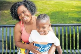  ?? E. JASON WAMBSGANS/CHICAGO TRIBUNE ?? Ida Nelson holds her son Gus “Jett” Hawkins, 4, on May 21 after Nelson braided his hair in March. Nelson got a call from Providence St. Mel informing her the braids were against the school dress code.