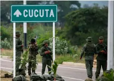  ??  ?? Venezuelan Bolivarian Army soldiers stand guard at the Tienditas Internatio­nal Bridge that links Colombia and Venezuela, near Urena, Venezuela, Friday. AP PhoTo/FernAndo LLAno