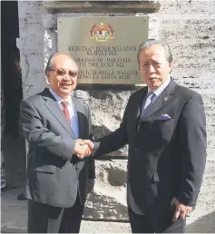  ??  ?? Anifah (right) shaking hands with Bernard after officiatin­g the Chancery of the Malaysian Embassy at The Holy See. — Bernama photo