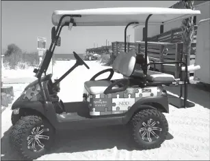  ?? Becky Large/AP ?? Cart: This photo shows a Champion Autism Network golf cart decorated with puzzle pieces, a symbol for autism, in Surfside, S.C., with the Surfside Pier in the background. The golf cart is sponsored by area businesses who purchase puzzle pieces and get...
