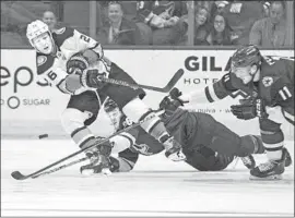  ?? DARRYL WEBB Associated Press ?? BRANDON MONTOUR, shooting against the Arizona Coyotes’ Christian Fischer and Brendan Perlini (11), says he wants to be a Duck for a long time.